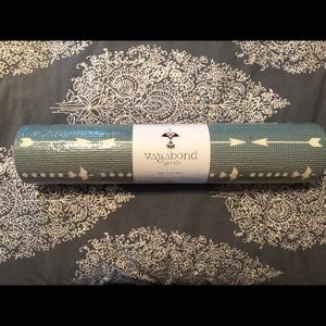 Vagabond holds yoga mat